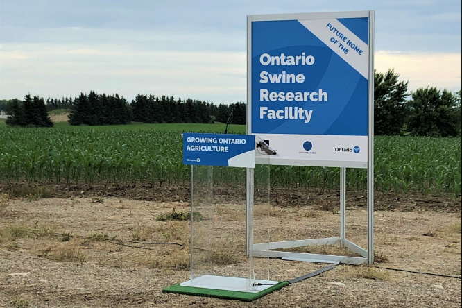 Sign in a field showing future home of the Ontario Swine Research Facility